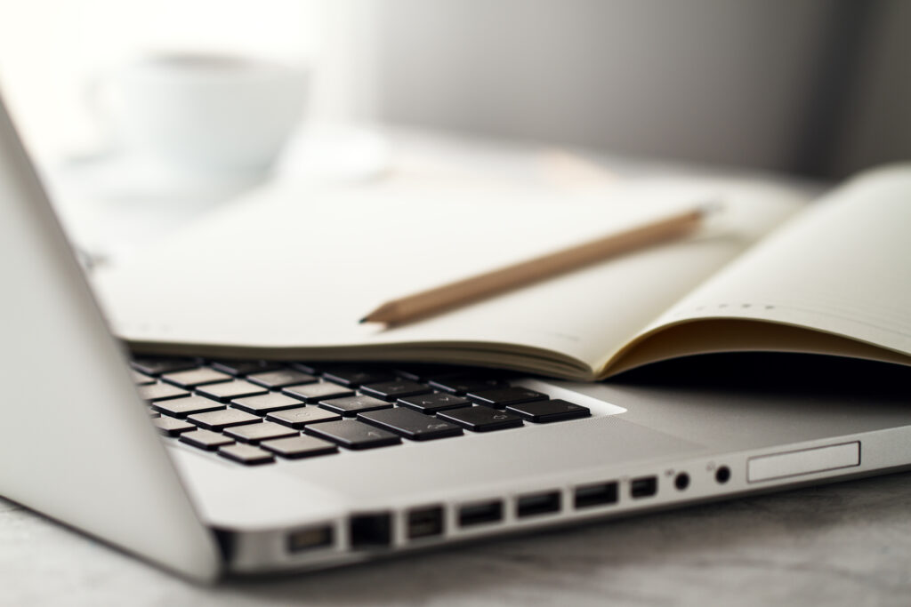 closeup of workspace with modern creative laptop, cup of coffee