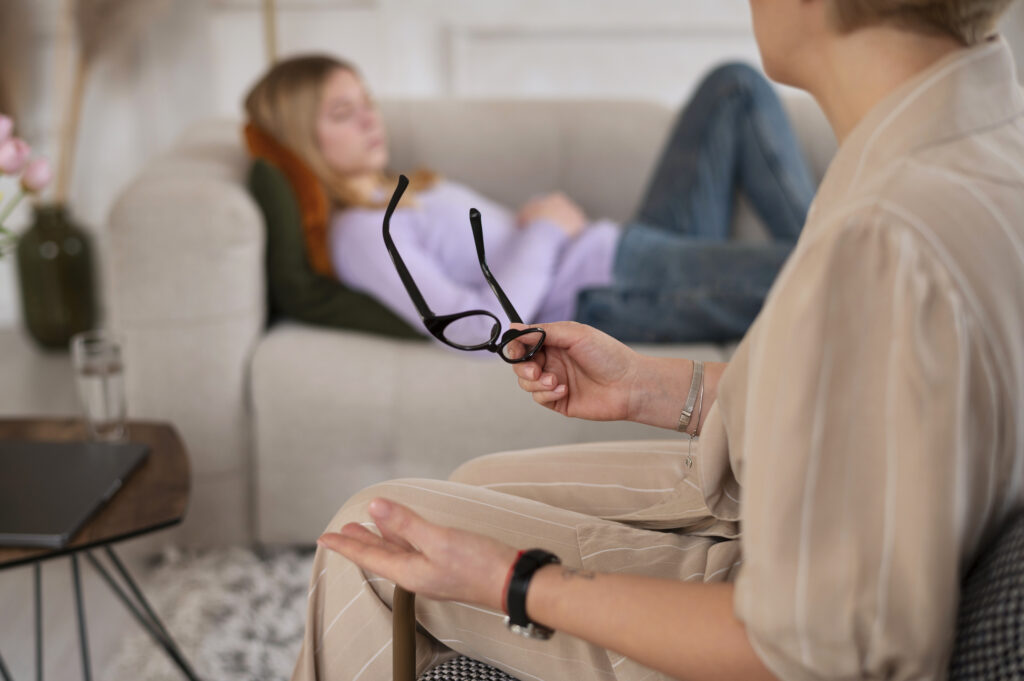 young girl talking therapist side view